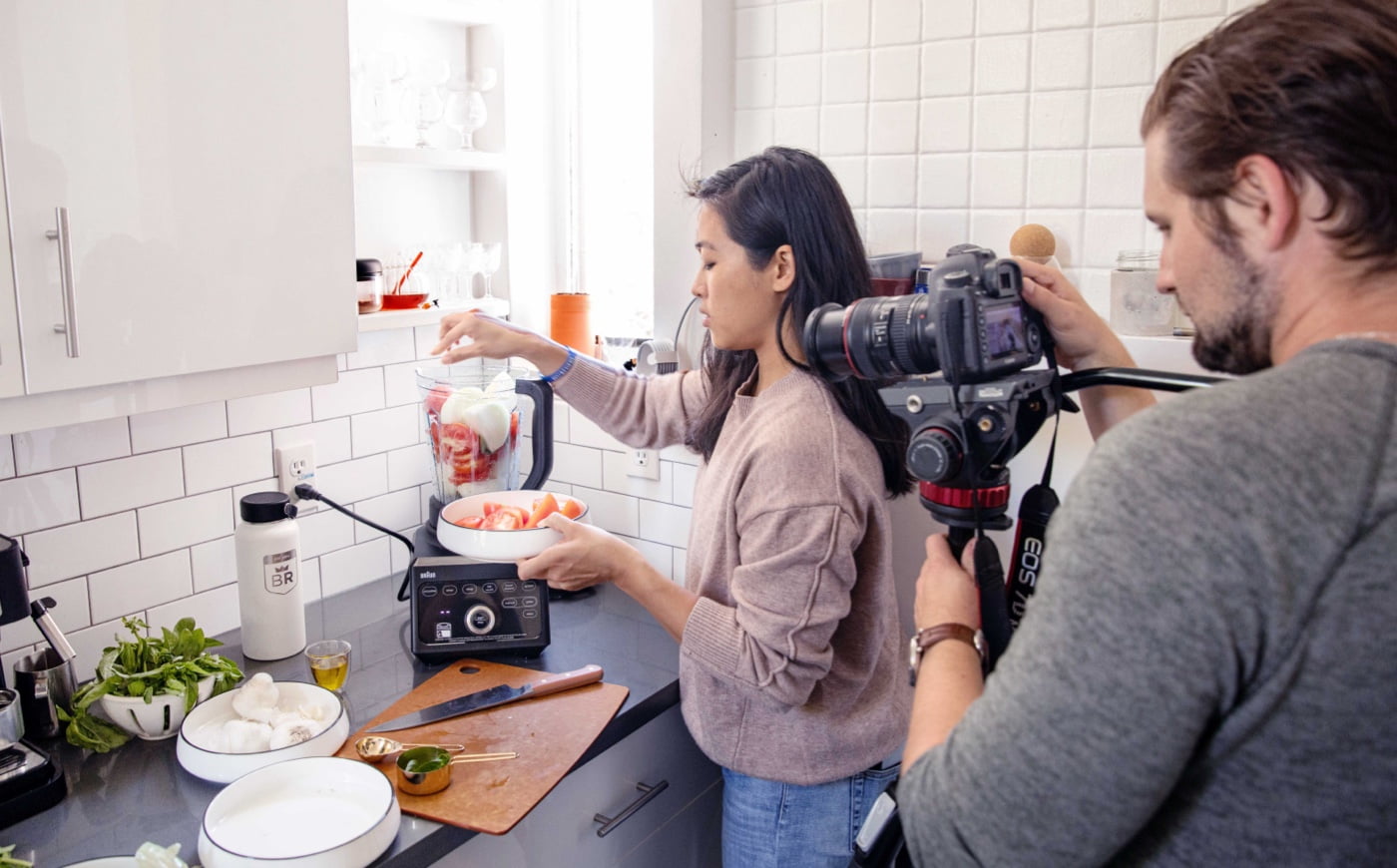 mаn filming a cooking woman